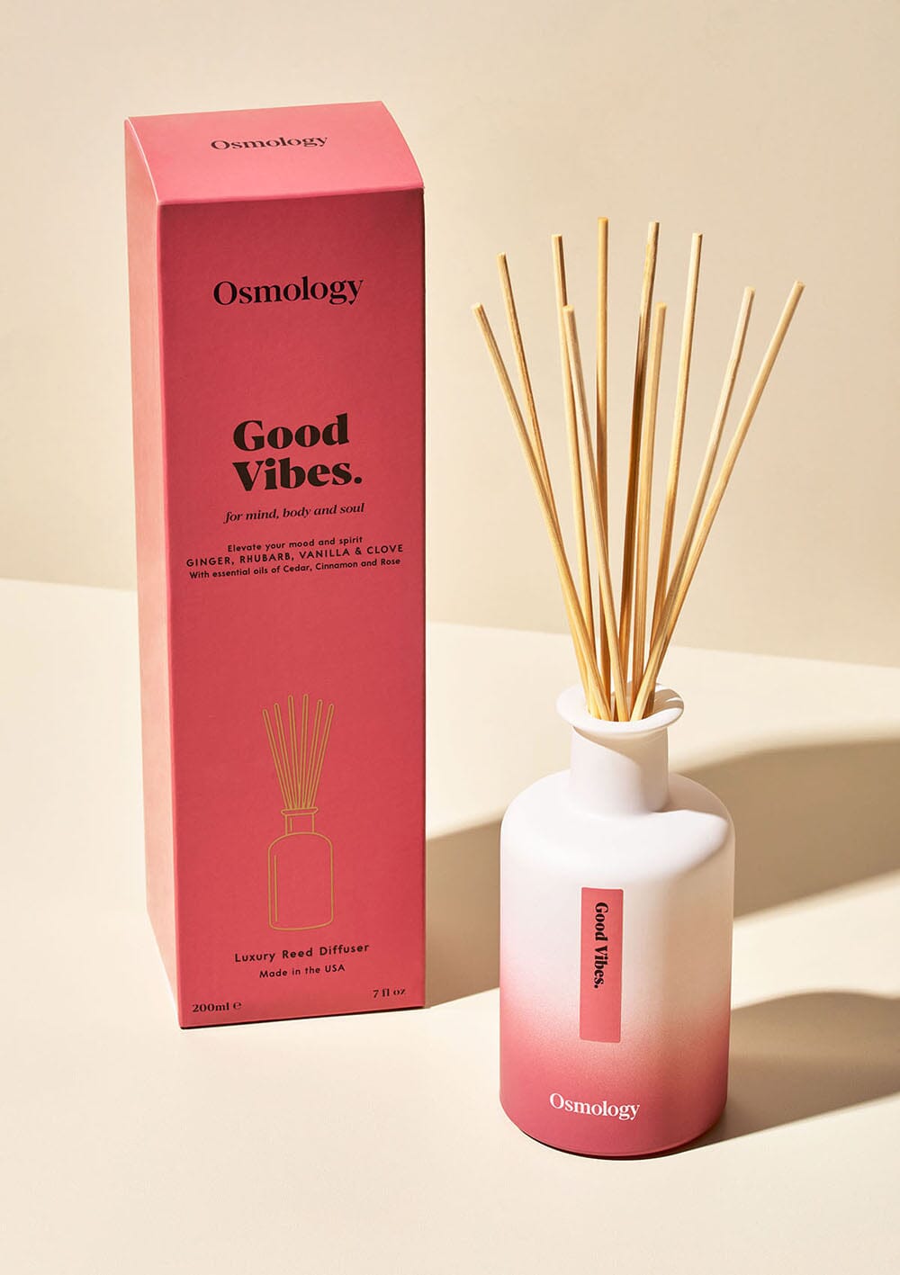 Osmology Good Vibes reed diffuser with product packaging, cream background 