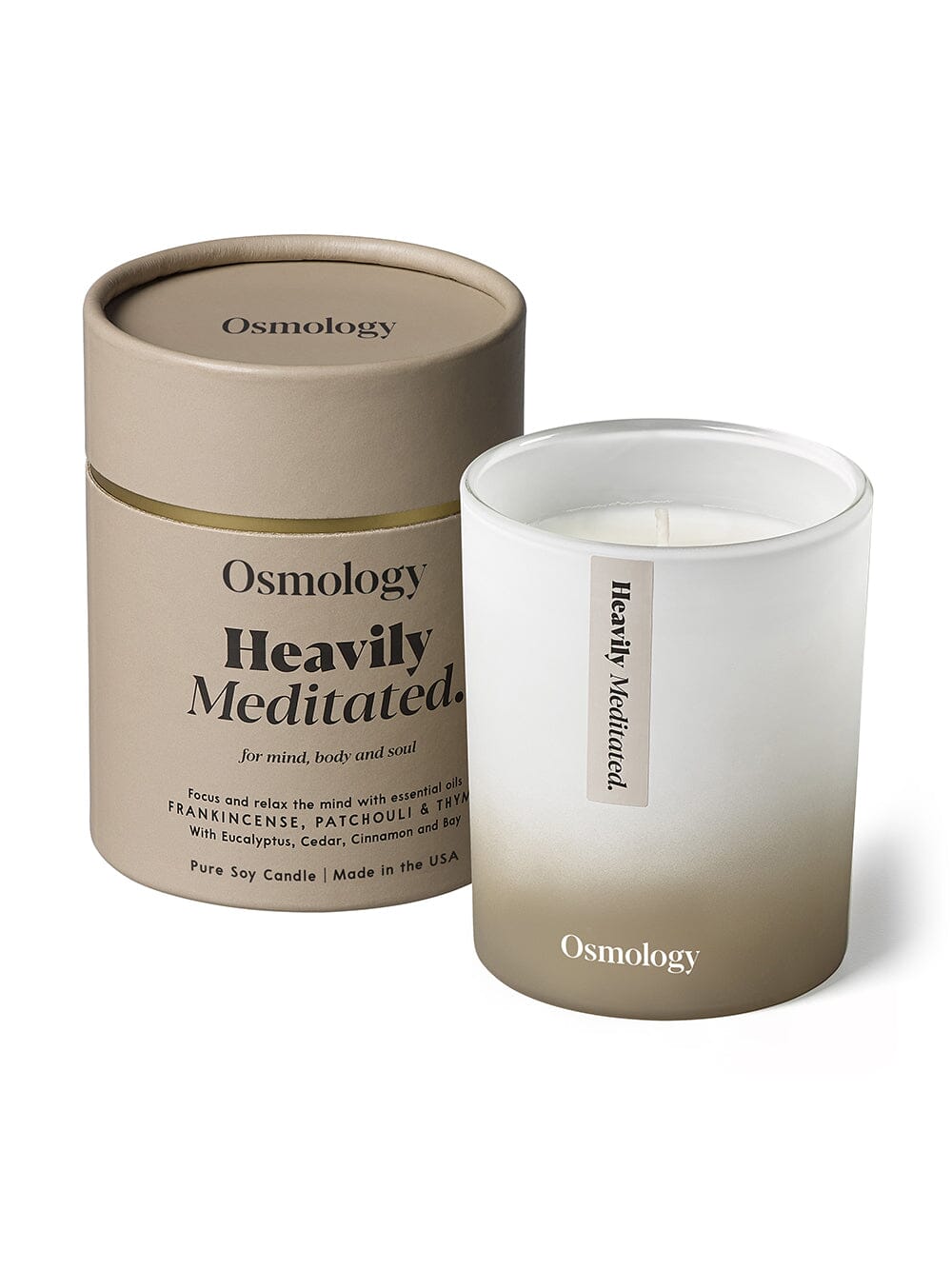 Osmology Heavily Meditated candle, with product packing tube on white background 