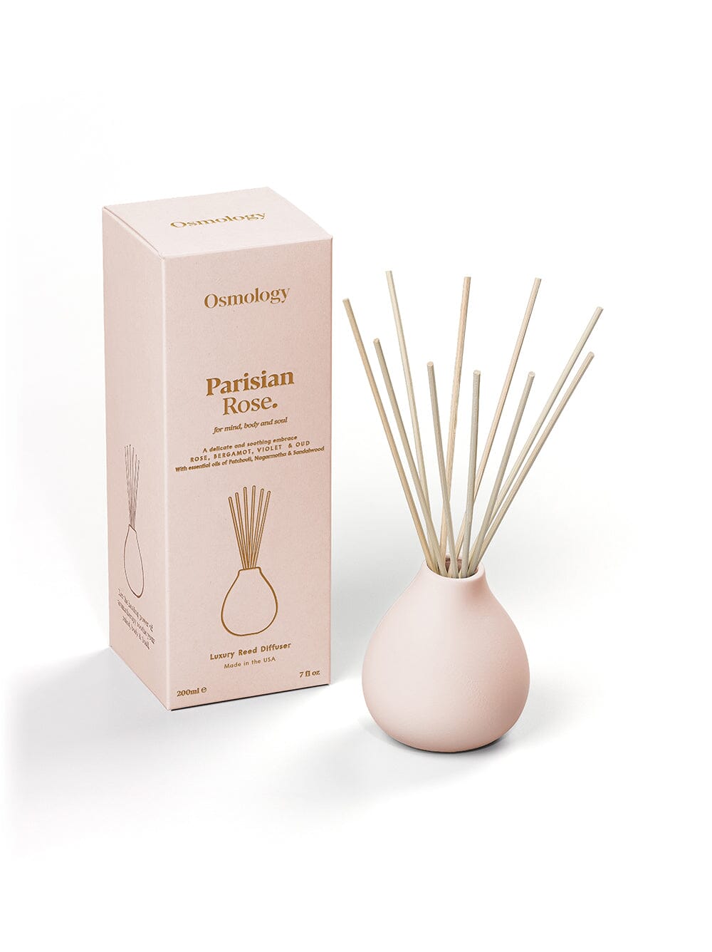 Osmology pale pink reed diffuser next to product packaging on a white background